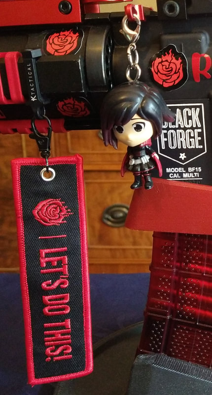 Official "Let's Do This!"/"RWBY" Flight Tag and Ruby Rose Charm. 